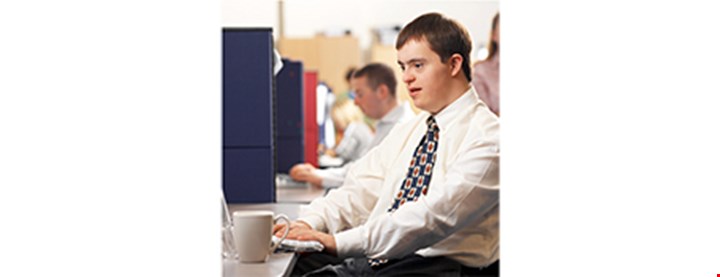 Illustrasjonsfoto av en person med Down syndrom som jobber på kontor